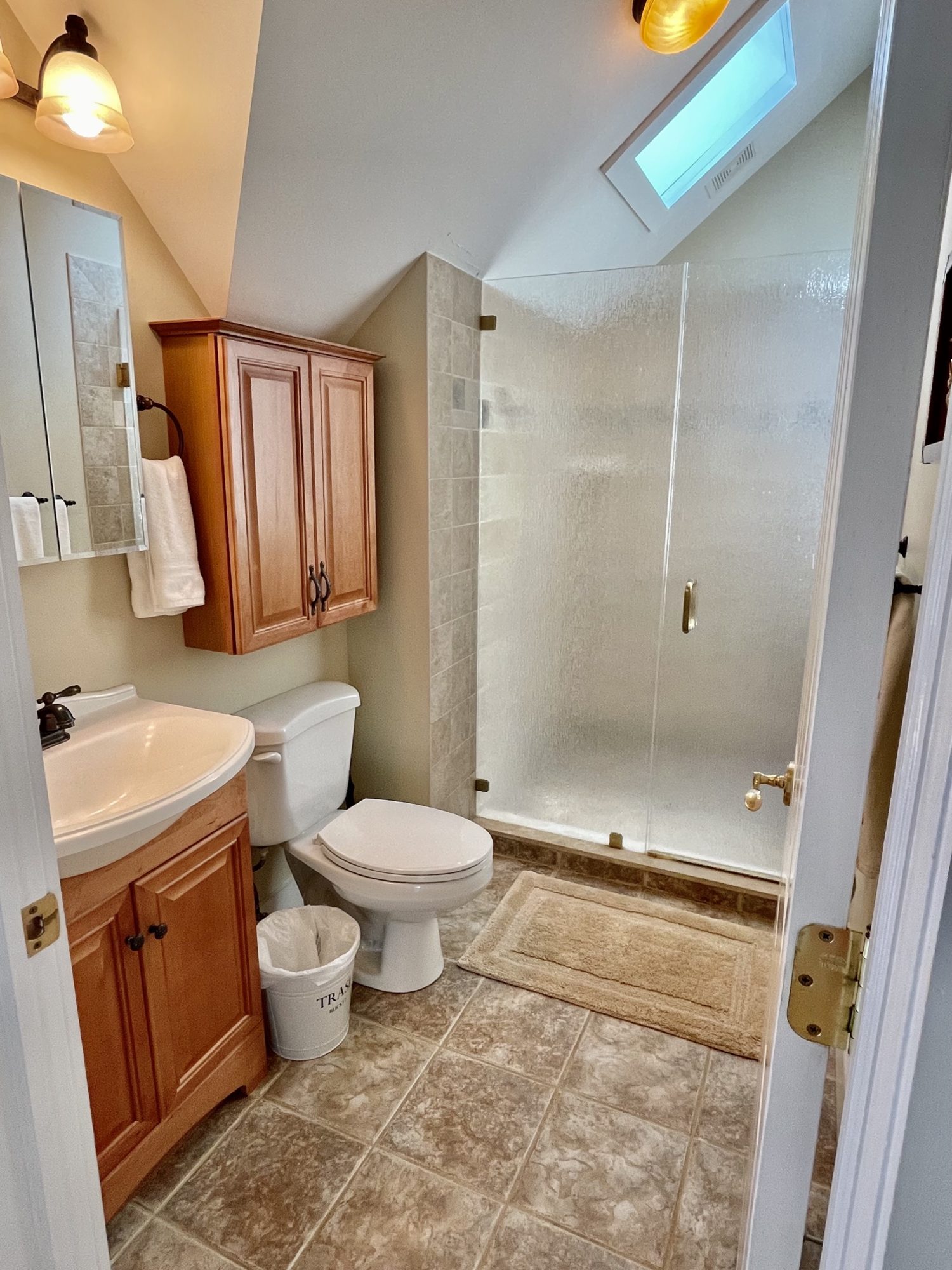 Upstairs shower under a skylight